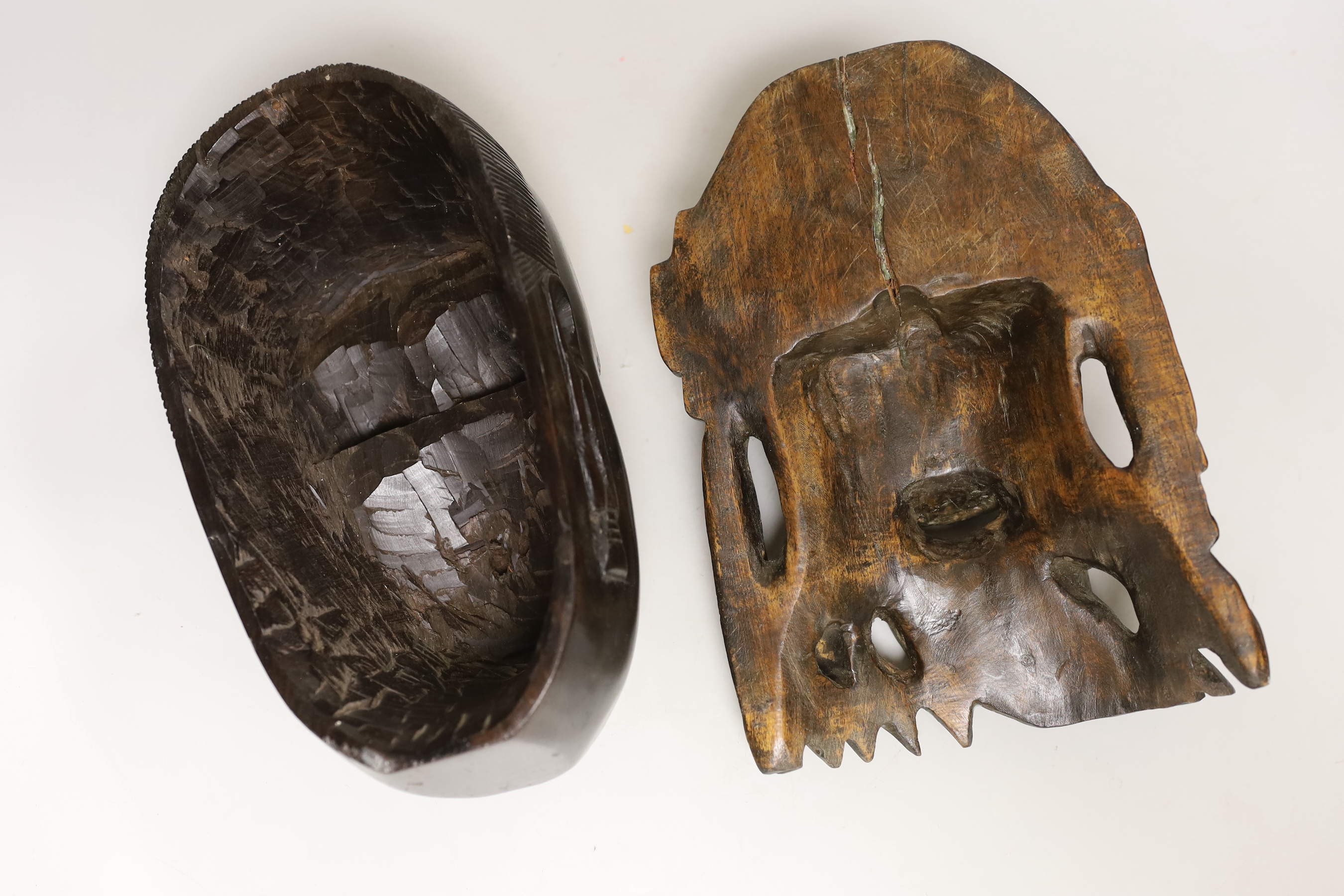 A Chinese Shou Lao wooden mask and an African mask, 26.5cm high